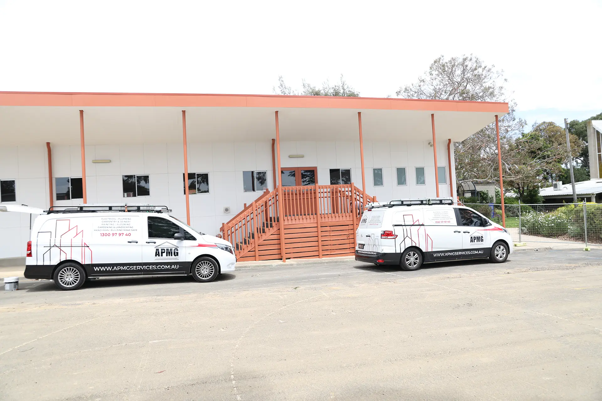 Multi-colour exterior scheme applied across a school building elevation at Emmaus College
